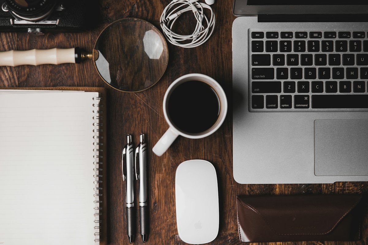 A creative studio with a laptop, sketches and a mug on the worktable